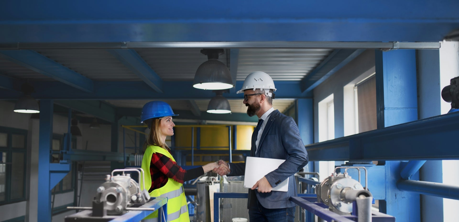 engineer-industrial-worker-uniform-shaking-hands-large-metal-factory-hall